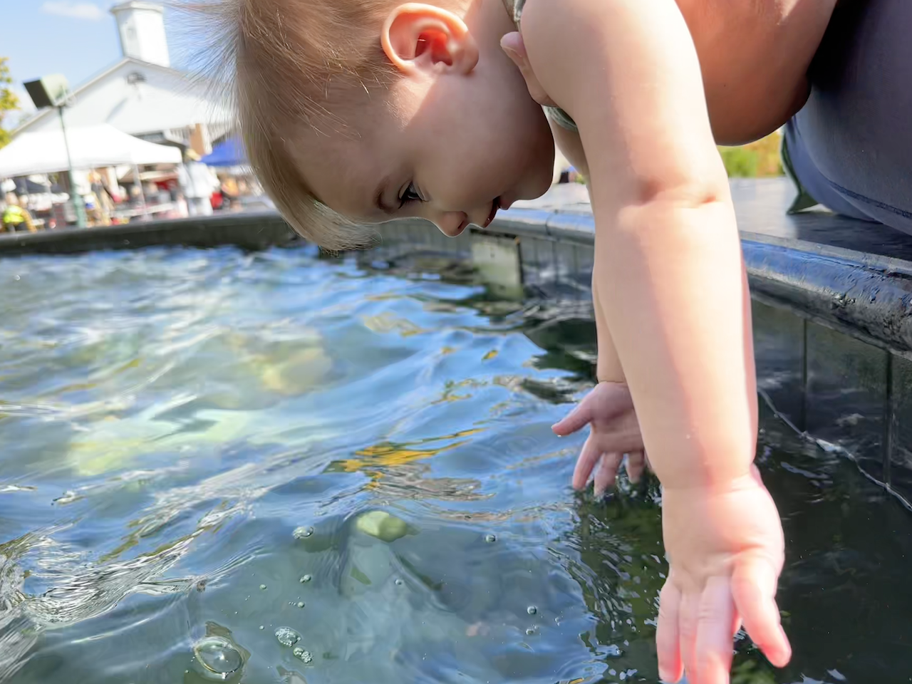Zoe playing in a water fountain.